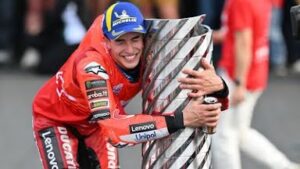Marc Márquez raising his arms in celebration on his Ducati at Motegi