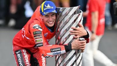 Marc Márquez raising his arms in celebration on his Ducati at Motegi